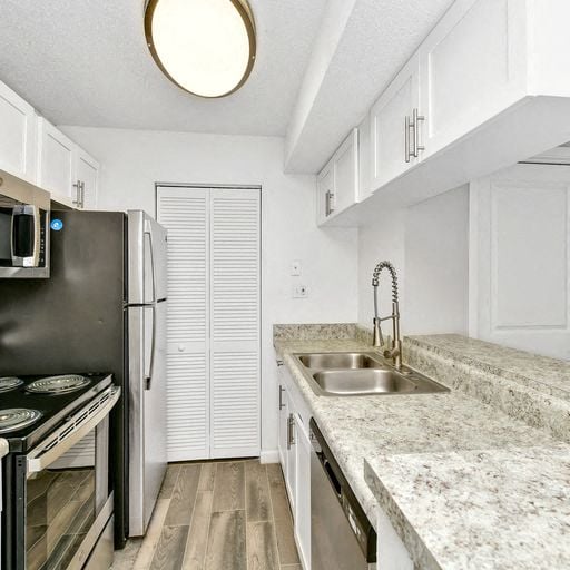 a kitchen with granite counter tops and a sink